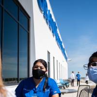 Students outside the Center for Interprofessional Health building sitting around a table